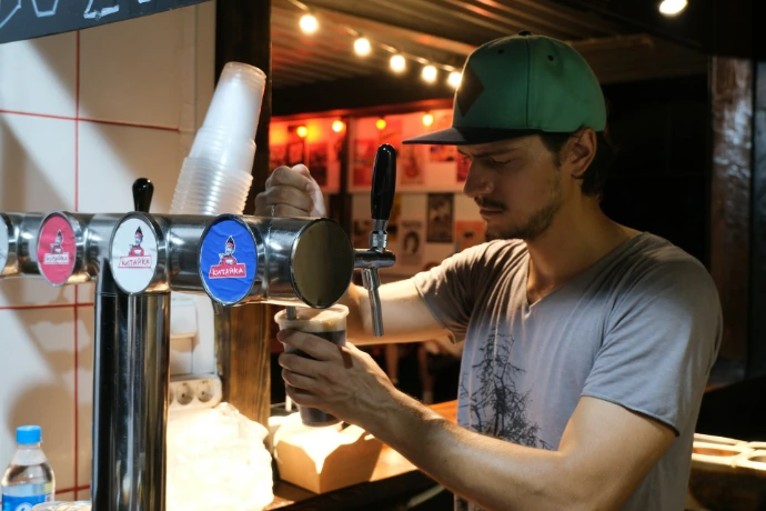 Bartender pouring a beer from a tap
